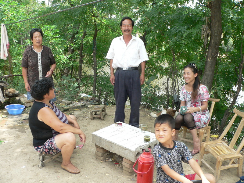 Ah Feng with Mrs Zhèng's mother, Mrs Zhèng (seated), Mr Liú and their son