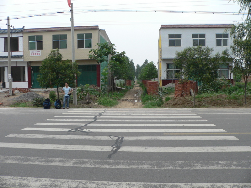 Ah Feng at the pedestrian crossing 460 m south of the confluence, which marks the beginning of a small dirt road, nestled between two houses