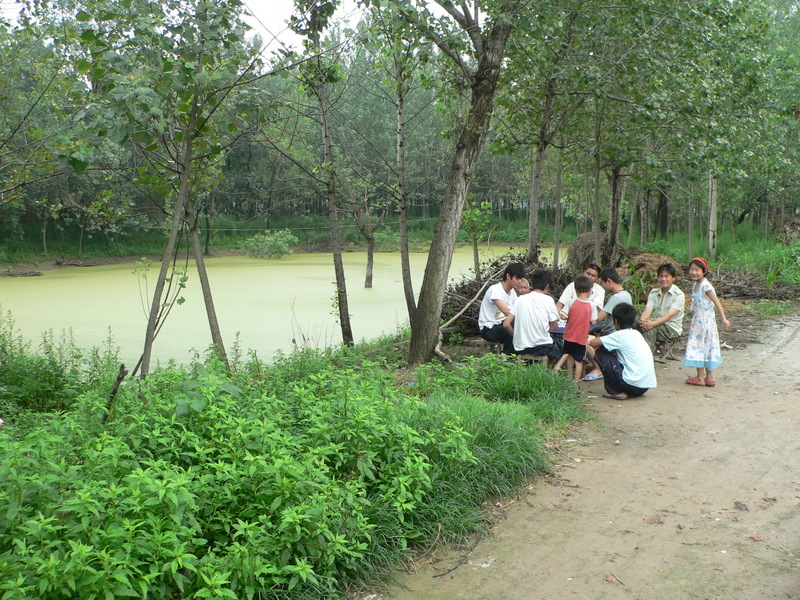 Locals playing mahjong next to the confluence pond