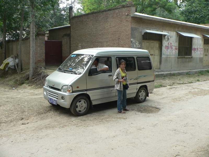Ah Feng next to our minivan, one block west of the confluence