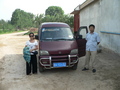 #3: Ah Feng and our driver, next to the minivan in Hābāgōu Village