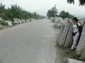 #3: Ah Feng amid the slabs of rock littering the side of the road