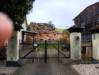 #7: building with sign at the gate