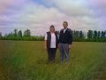 #3: Looking north at Mr.and Mrs. Nygaard standing on the confluence, located on one of their fields.