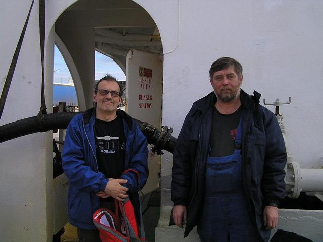 Chief Engineer Valeriy from Russia and Captain Peter in front of the bunker hose