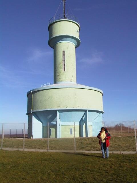 Erika at the confluence point, water tower in the background
