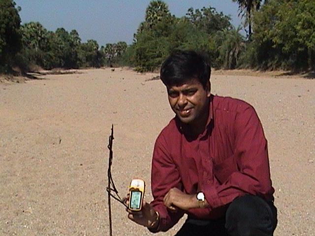Anupam at the confluence point with a smile on face and GPS in hand