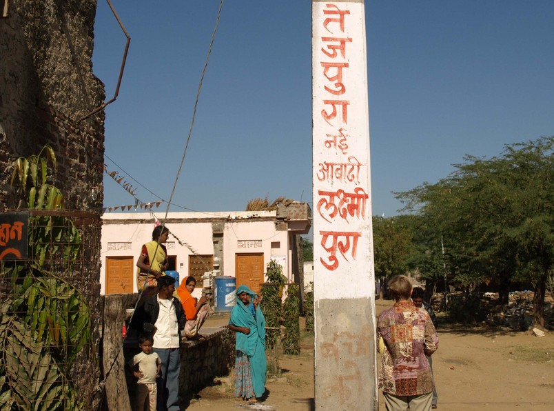 Local Residents.  The Village Name, Tejpura, Is Written On The Utility Pole.