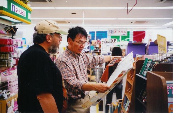 Abe san helping to get a good map at book store.