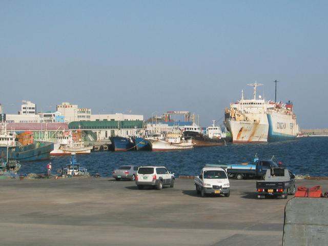 Sokcho harbor with big Russian ferry to right rear, Chinese cargo boats in front of it.