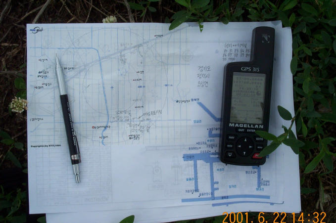 The GPS on the confluence showing the location, along with the printed map used to find the confluence.