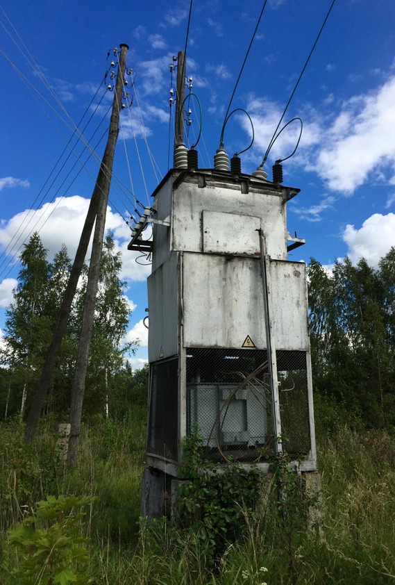 An old, dangerous-looking Soviet-era electrical transformer, beside the road, 500 m from the point