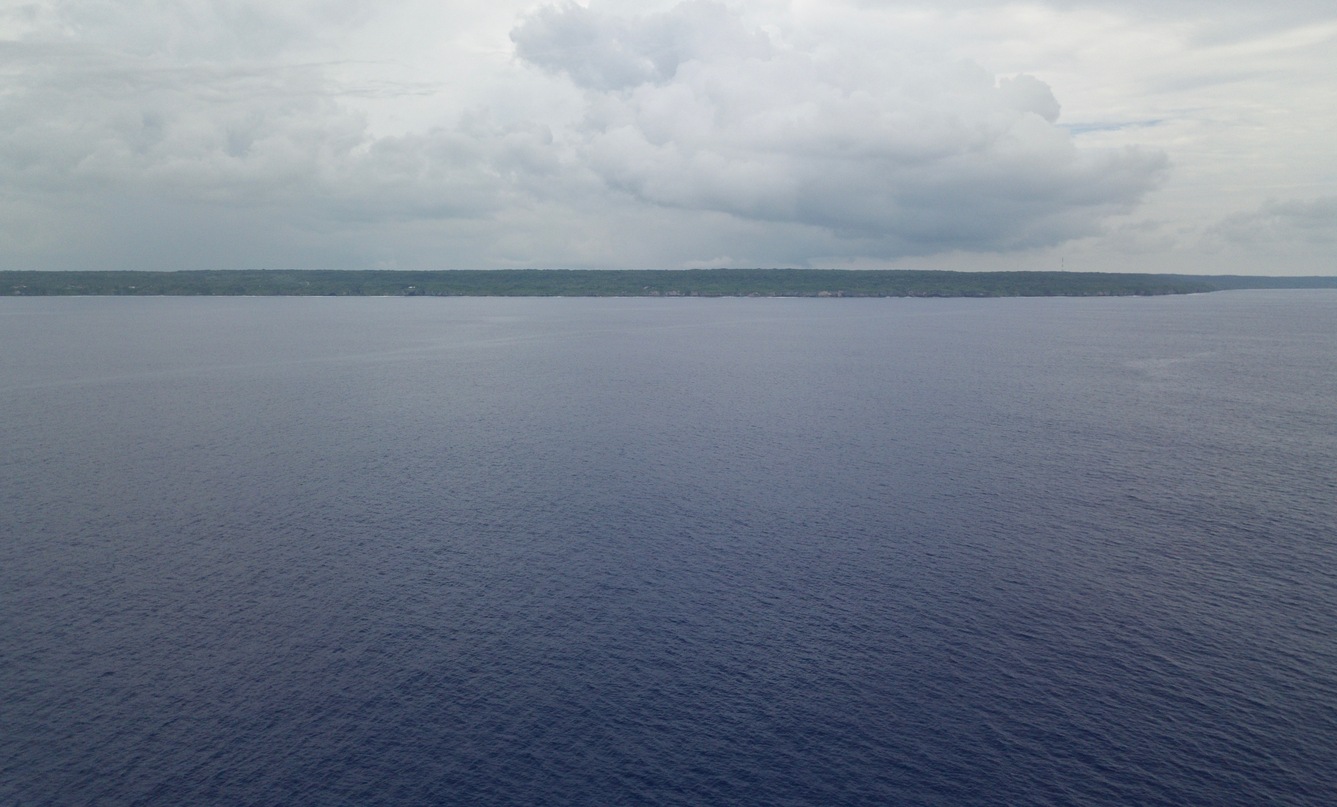 A drone’s eye view of Niue from 18.9839°S 169.9375°W, at ~50 m above the ocean. The confluence point is about 7 km farther away than this, but a shipboard view from the point might be similar.