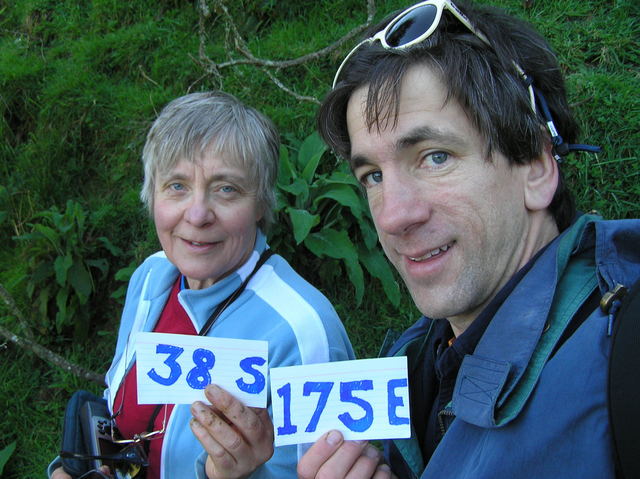 Anne Olsen and Joseph Kerski celebrate confluence arrival without falling down on the steep slope.