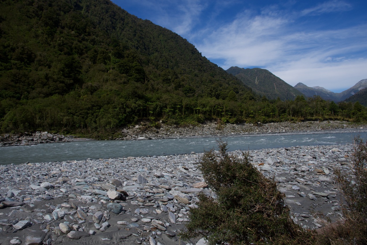 The confluence point lies on the bank of the Hokitika River.  (This is a view to the East, across the river.)