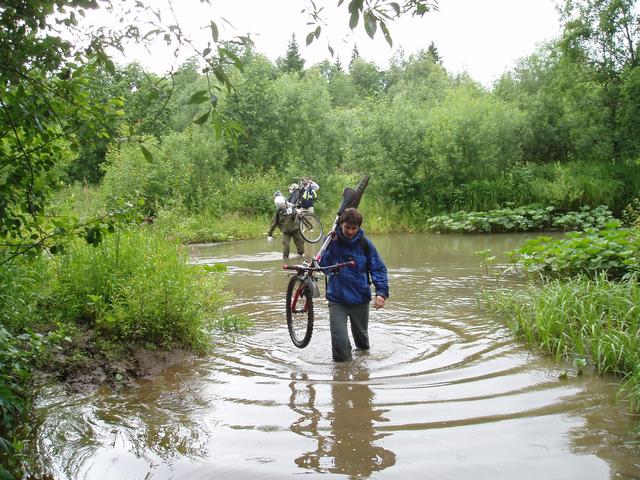 forcing the ford of the Beryozovka [Russian: flowing through birch-forest] river, with bikes being carried upon shoulders