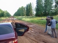 #5: Greg strategizing with Jesse and Evgeny how to cross the giant mud puddle.  Evegeny's Nissan on the left.