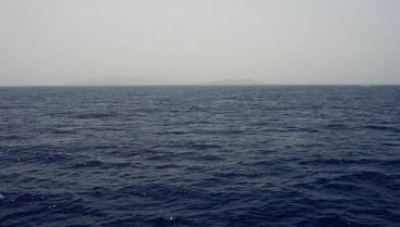 #1: View looking SE at 25N 37E with reef break waves and distant Hasāniyy and Libāna Islands