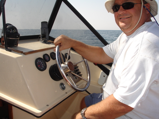 Arch at the wheel of his motorboat