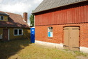 #7: House with toilet seen from parking area