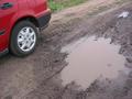 #8: Pothole on dirt road