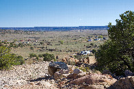 #7: Looking down towards the nearby residences from a hill 0.1 miles from the point.  (The trailer home in the center-right is very close to the point.)