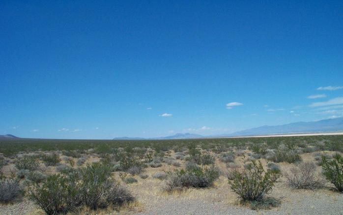Looking north, across the dry lake on the right you can partially make out the town of Pahrump