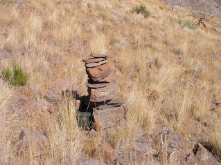 #1: The confluence point lies near this rock cairn (and geocache), near the top of a rocky, grassy hillside