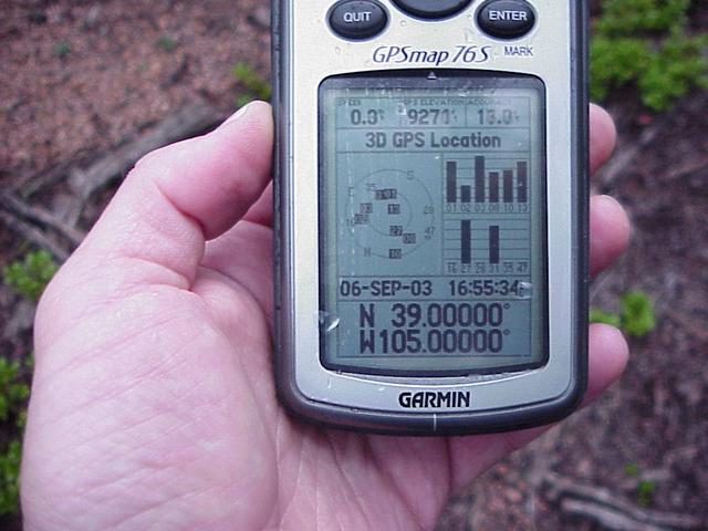 Raindrops on GPS unit as it records the confluence's location.