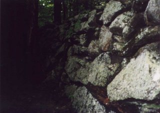 #1: A tall stone wall at the confluence.