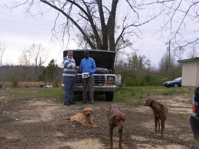 Dad and land owner with dogs in foreground