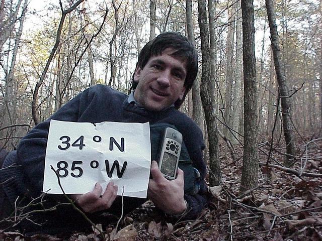 Joseph Kerski at 34 North 85 West, lying in a Georgia forest.