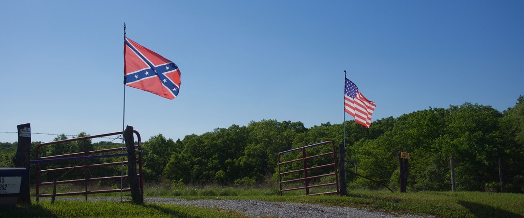 A nearby farm entrance, proudly flying both the American flag, and the Confederate battle flag