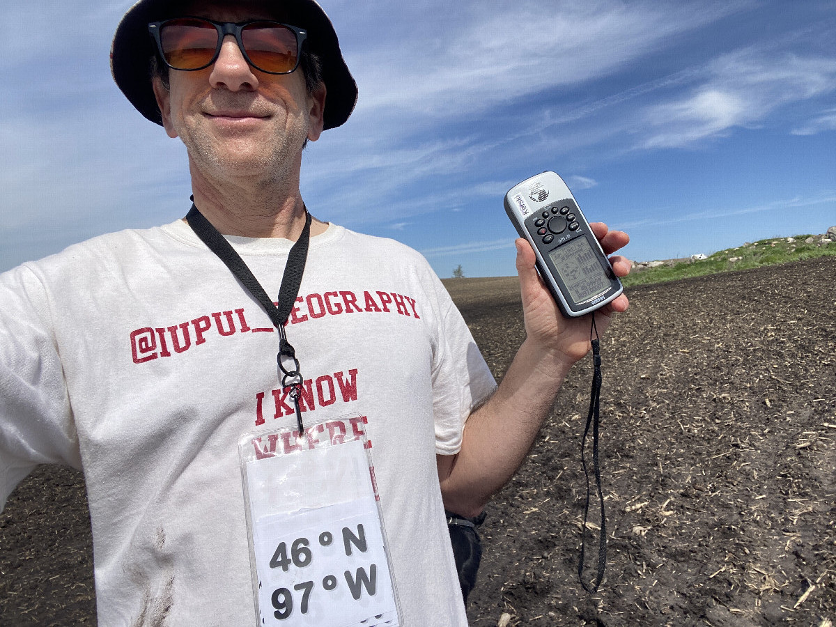 Joseph Kerski with Geography shirt at the confluence point.