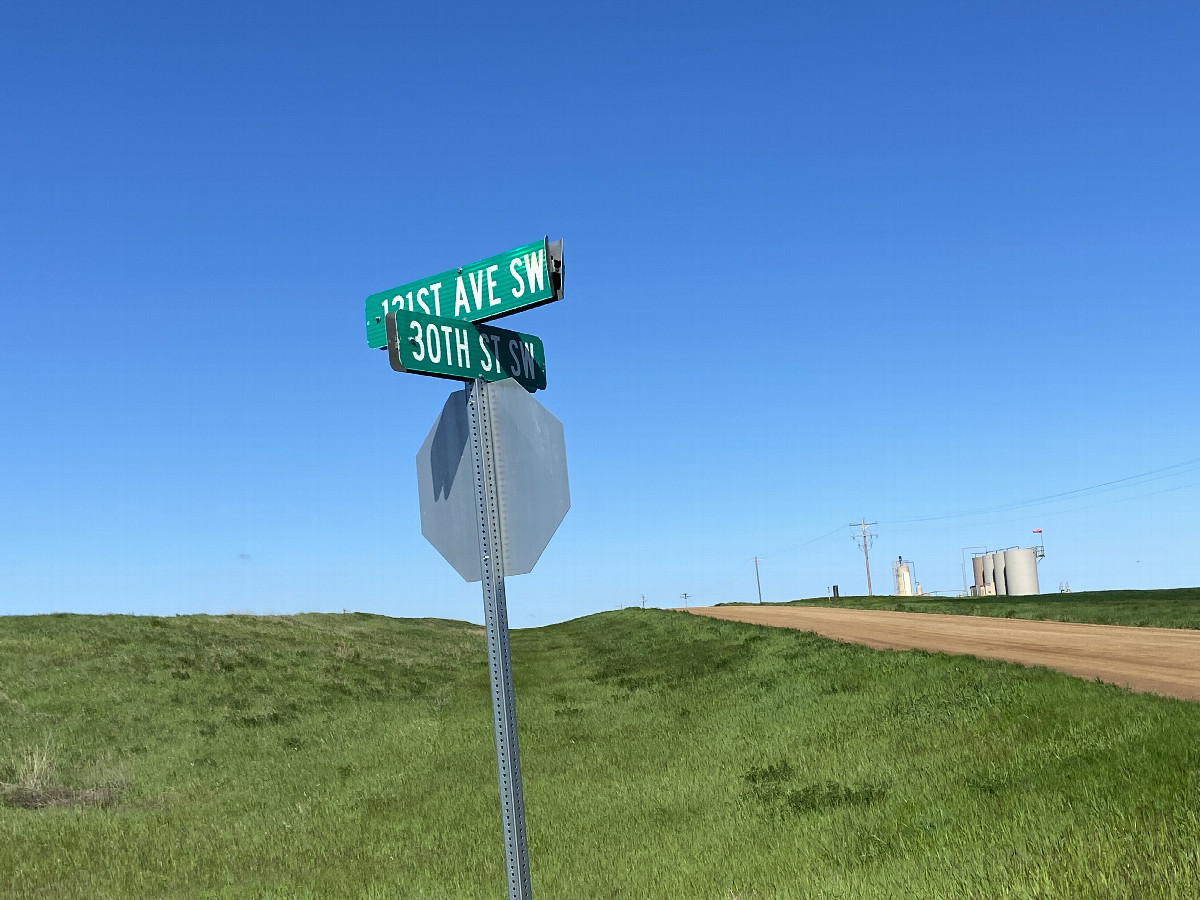 Nearest roads to the confluence, showing rolling terrain, fields, and some oil and gas infrastructure. 