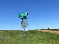 #10: Nearest roads to the confluence, showing rolling terrain, fields, and some oil and gas infrastructure. 