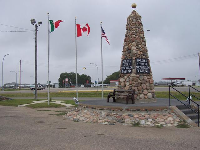 Geographical Center of North America in Rugby, ND with the flags of Mexico, Canada and the USA.