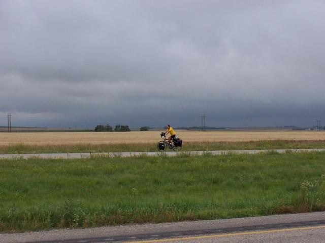 A lone cyclist pedaling towards the center of North America.