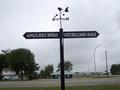 #3: Mileposts pointing South and North.
