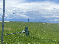 #10: Road sign of the road leading to the confluence point looking at threatening thunderstorm toward my next destination. 