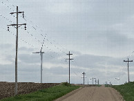 #10: Confluence surroundings:  Grain bins, fields, telephone lines, and wind turbines. 