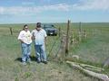 #3: Rae Stone Man and John Whiting stand near the fences that mark the historical surveyed 43 N 103 W point.