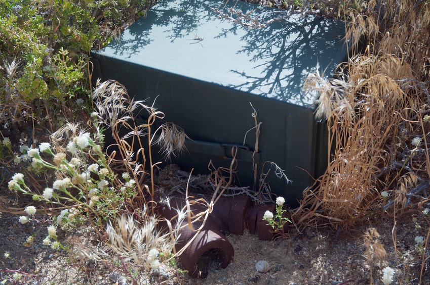 A ‘geocache’ box (new in the past 10 years), next to the confluence point’s famous rusted steel pipe