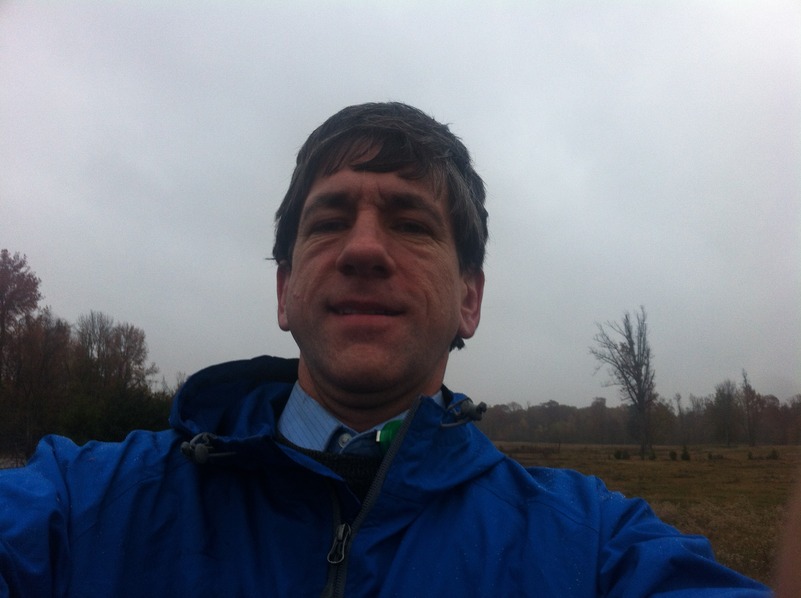 Joseph Kerski at the confluence point in the rain.