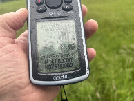 #6: GPS reading in the rain at the confluence point.