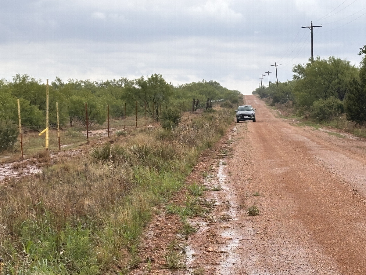 A familiar sight:  My vehicle on a lonely road.  Nearest road to the confluence, to the south of the point.