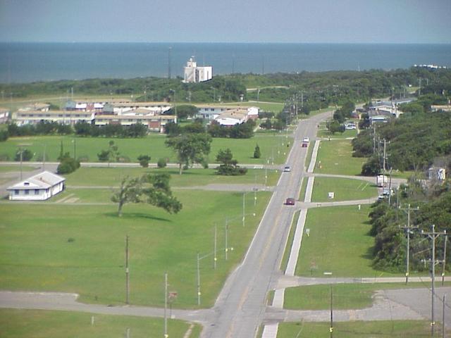 View east from the lighthouse; longitude 76 crosses the road just ahead of the farthest car on the road.
