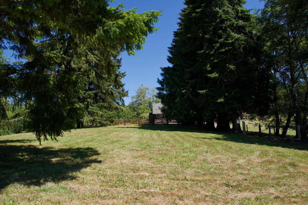 The confluence point lies 143 feet away, in the front yard of this private residence.  (This is also a view to the East.)