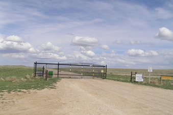 #1: No trespassing sign and gate barring access to the area near the confluence on the approach from the west.