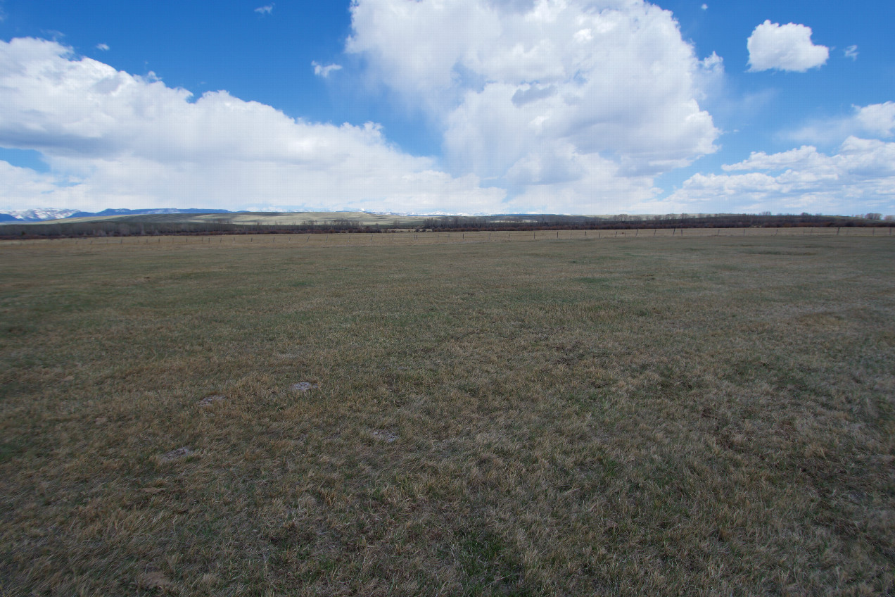 The confluence point lies in flat ranchland.  (This is also a view to the East, towards the Wind River Range)